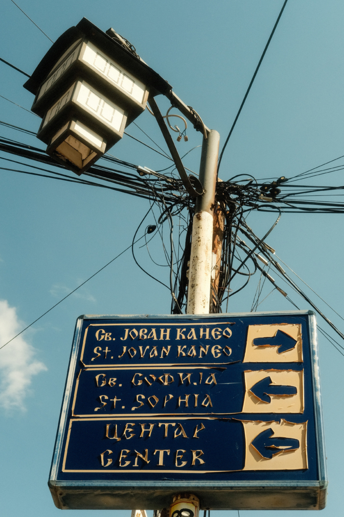 Old signpost under a lantern.