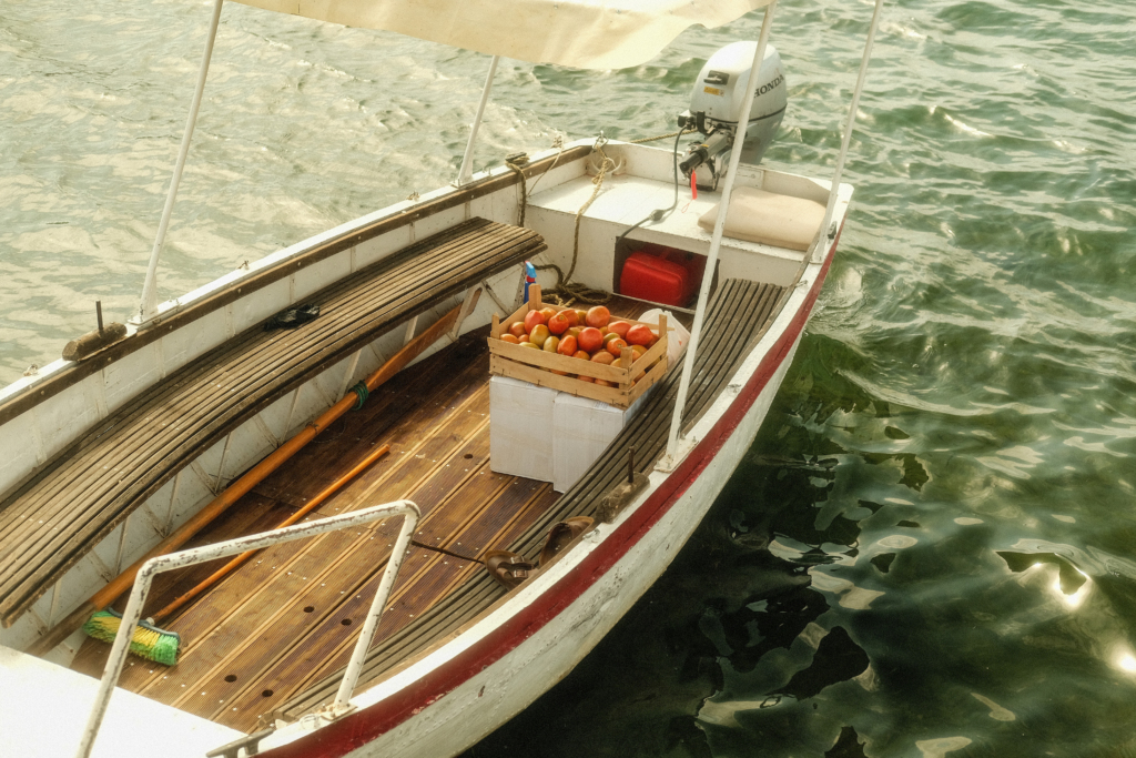 A box of tomatoes on a boat.